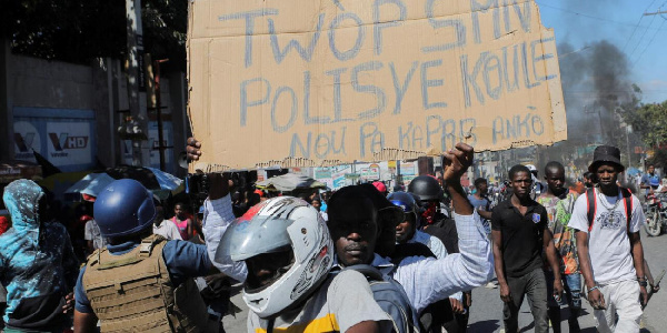 Haitian police personnel block roads, flood airport to protest killing of officers by armed gangs