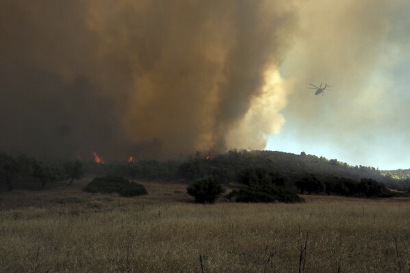 Greece wildfires: 18 bodies found as firefighters battle wind-driven wildfires across the country